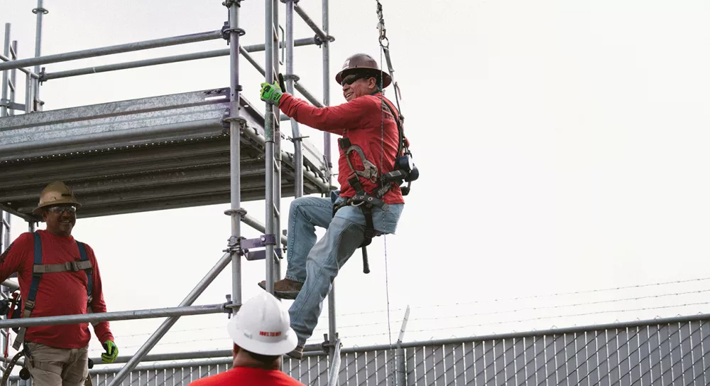 Scaffold builder climbing to elevated platforms